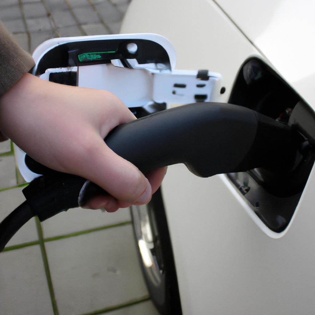 Person using electric vehicle charger